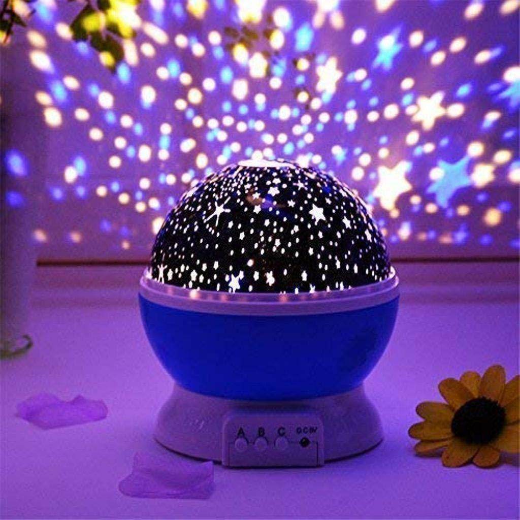 Blue star projector night light casting colorful star and dot patterns on purple wall