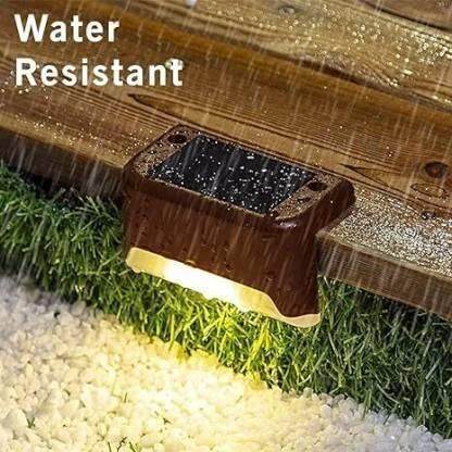 Water-resistant outdoor solar stair lights mounted on wooden steps glowing in the rain