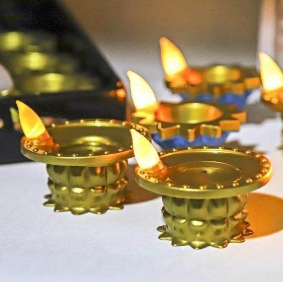 Golden LED water pouring diya light set with warm glowing flames for festive decoration