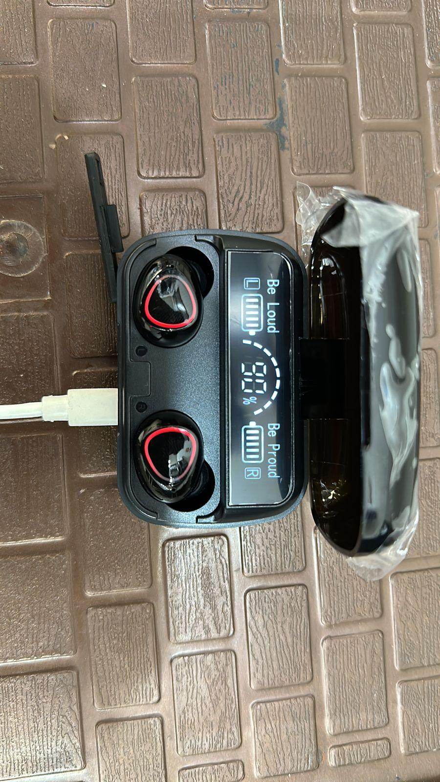 M10 Pro wireless earbuds in black charging case with LED battery display plugged into USB charger