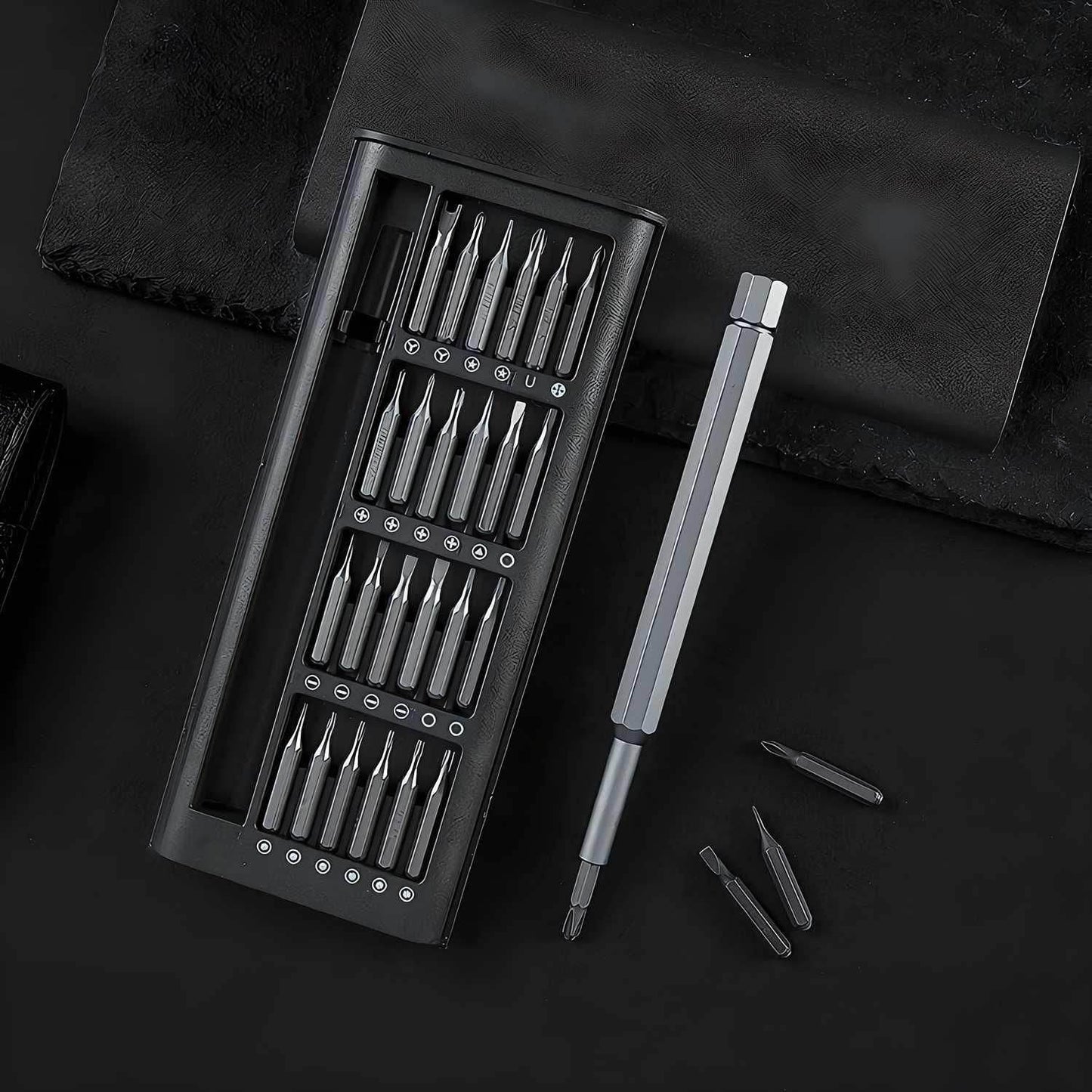 Precision screwdriver set online with multiple metal bits and a silver handle in a black case